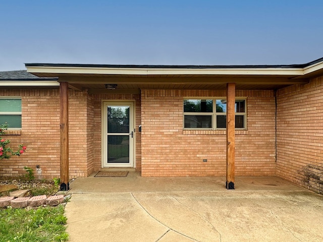 111 N 24th St, Lamesa, TX 79331 - doorway to property with brick siding and a patio