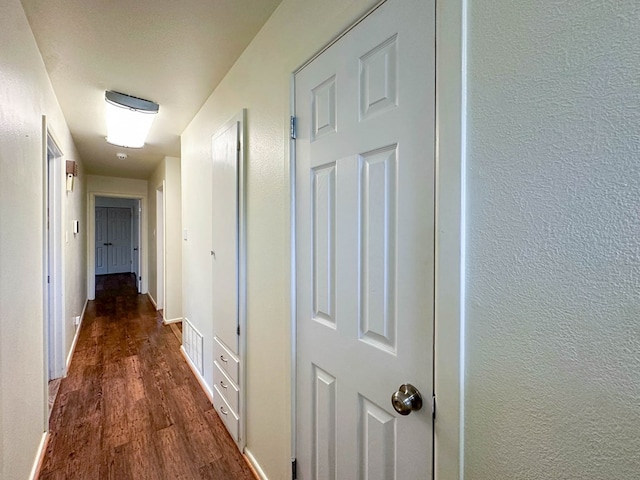 111 N 24th St, Lamesa, TX 79331 - hallway with wood finished floors, baseboards, and a textured wall