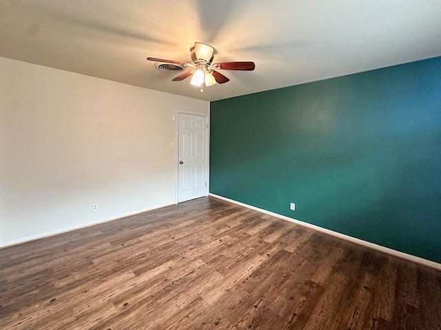 111 N 24th St, Lamesa, TX 79331 - unfurnished room with a ceiling fan, dark wood-style floors, and baseboards