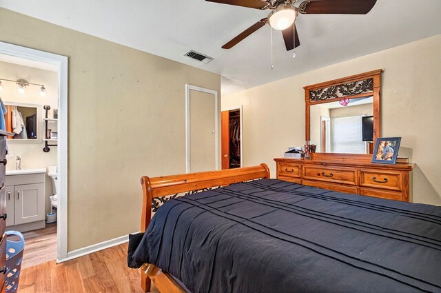811 NW 7th St, Andrews, TX 79714 - bedroom with light wood-style flooring, ensuite bathroom, baseboards, and a ceiling fan