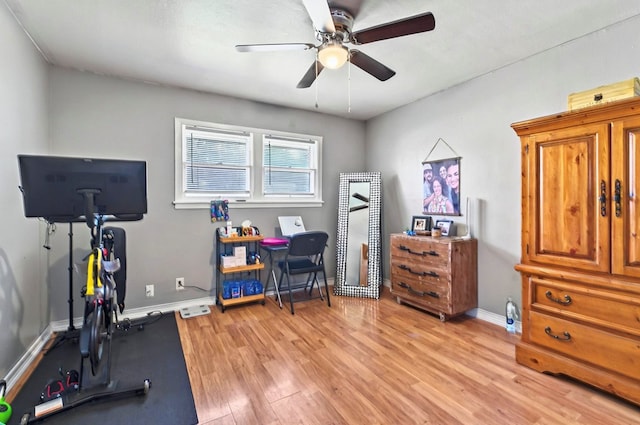 811 NW 7th St, Andrews, TX 79714 - exercise area featuring light wood-type flooring, a ceiling fan, and baseboards
