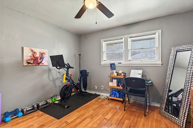 811 NW 7th St, Andrews, TX 79714 - workout room with wood finished floors, ceiling fan, and baseboards