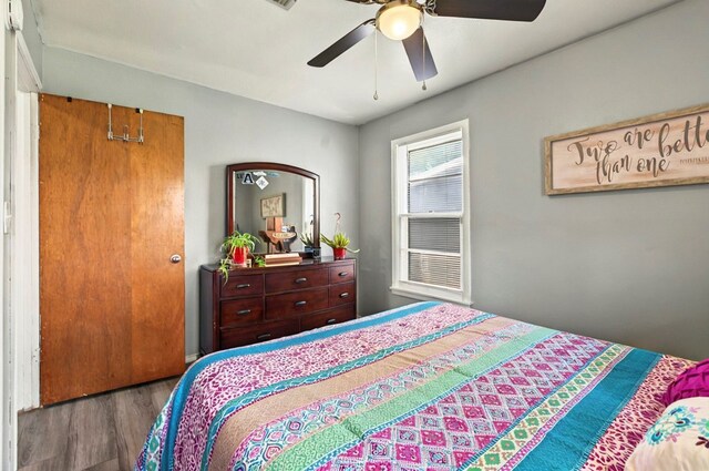 811 NW 7th St, Andrews, TX 79714 - bedroom with wood finished floors and ceiling fan