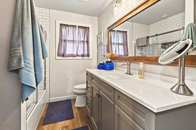 811 NW 7th St, Andrews, TX 79714 - full bath featuring vanity, toilet, wood finished floors, and baseboards