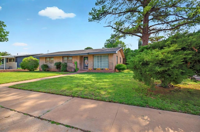 811 NW 7th St, Andrews, TX 79714 - ranch-style house with a front lawn and brick siding