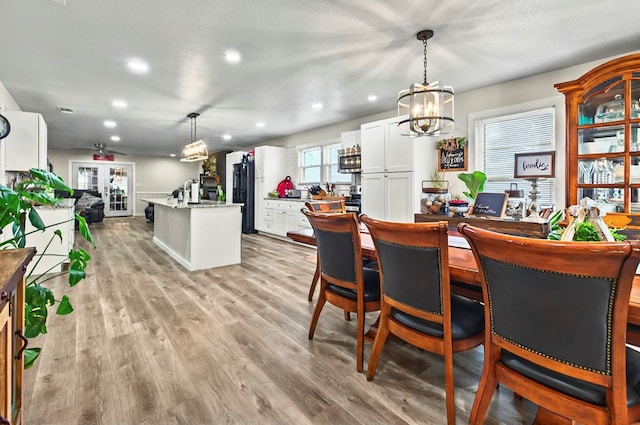811 NW 7th St, Andrews, TX 79714 - dining space featuring a chandelier, recessed lighting, light wood-style flooring, and baseboards