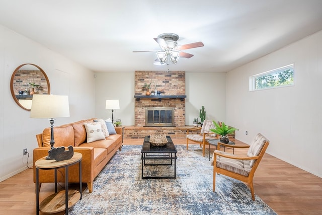 1403 E 17th St, Odessa, TX 79761 - living area featuring wood finished floors, a ceiling fan, a brick fireplace, and baseboards