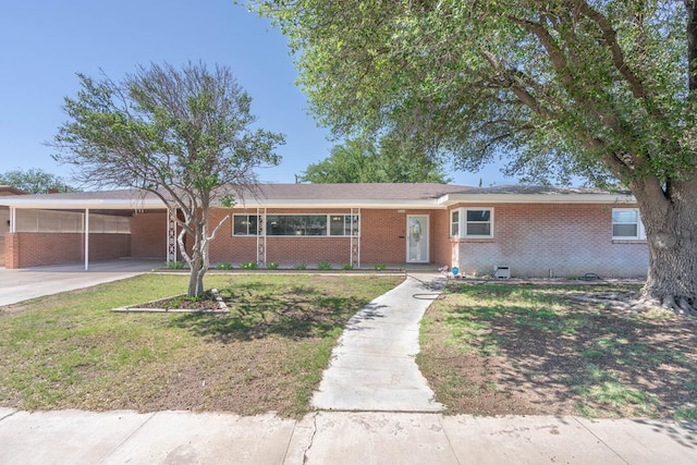 1403 E 17th St, Odessa, TX 79761 - ranch-style house with brick siding, a front yard, an attached carport, and concrete driveway