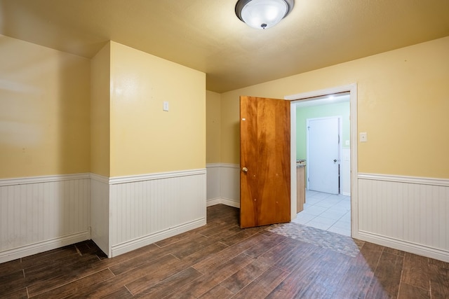 1403 E 17th St, Odessa, TX 79761 - empty room featuring wood-type flooring and a wainscoted wall