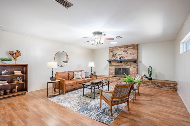 1403 E 17th St, Odessa, TX 79761 - living room featuring ceiling fan, wood finished floors, and a brick fireplace