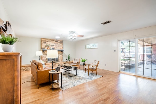1403 E 17th St, Odessa, TX 79761 - living room with light wood-style flooring, ceiling fan, and a fireplace
