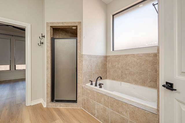 bathroom featuring hardwood / wood-style floors and shower with separate bathtub