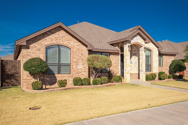 french provincial home featuring a front lawn