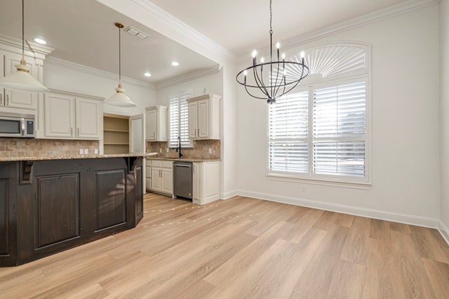 kitchen featuring white cabinetry, pendant lighting, light stone countertops, and appliances with stainless steel finishes