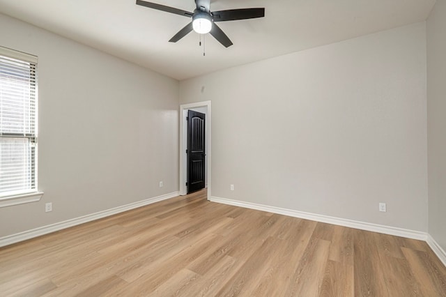 empty room featuring light hardwood / wood-style flooring, ceiling fan, and a healthy amount of sunlight