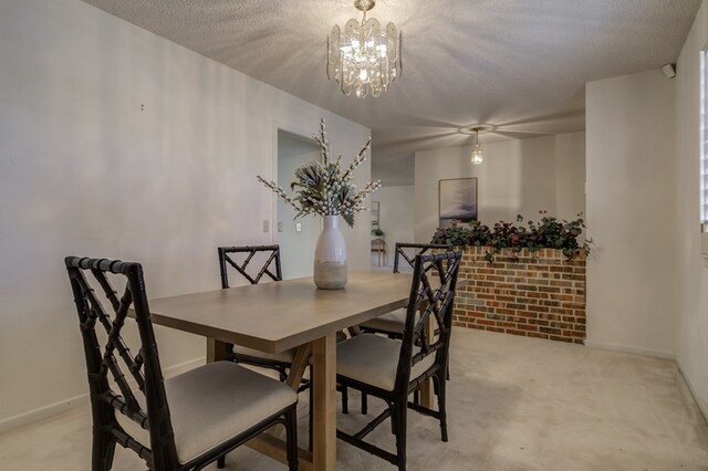 dining area featuring light colored carpet, a textured ceiling, baseboards, and an inviting chandelier