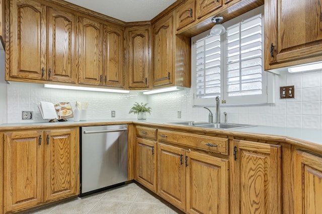 kitchen with dishwasher, brown cabinets, and a sink