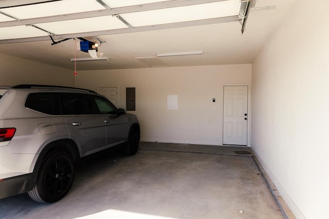 garage featuring electric panel and a garage door opener