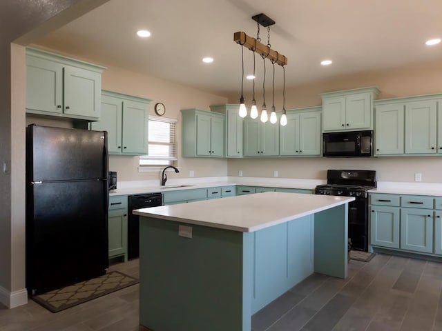 kitchen featuring a kitchen island, sink, hanging light fixtures, and black appliances