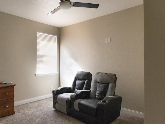 sitting room featuring ceiling fan and light colored carpet