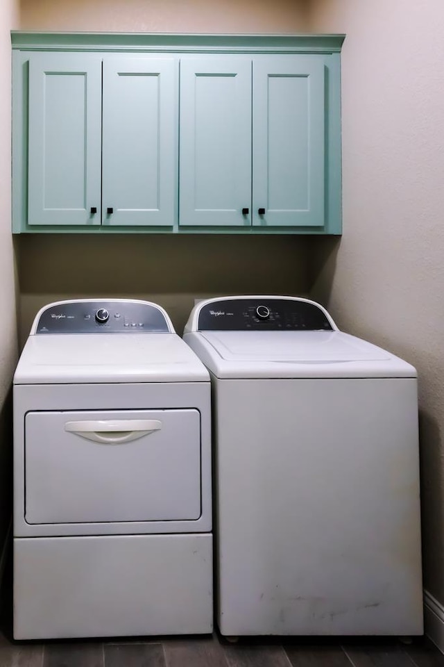 laundry room featuring cabinets and washing machine and clothes dryer