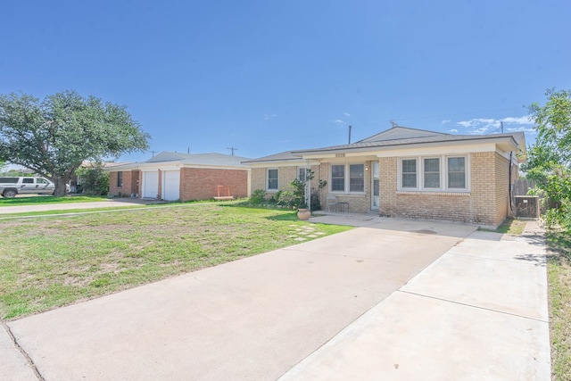 ranch-style home featuring a garage, a front yard, and central AC