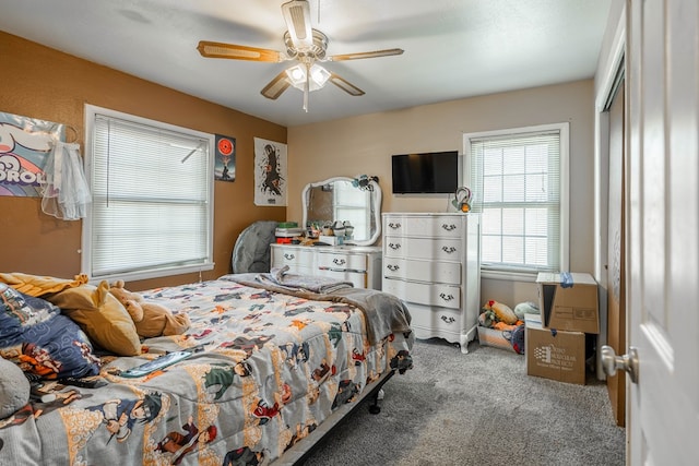 bedroom featuring ceiling fan, light colored carpet, and a closet