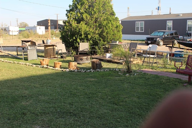 2711 W 83rd St, Odessa, TX 79764 - view of green lawn with an outdoor fire pit