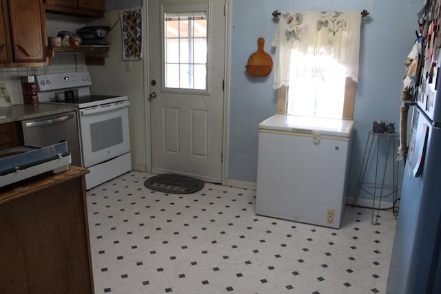 2711 W 83rd St, Odessa, TX 79764 - kitchen featuring white electric range oven, light flooring, and open shelves