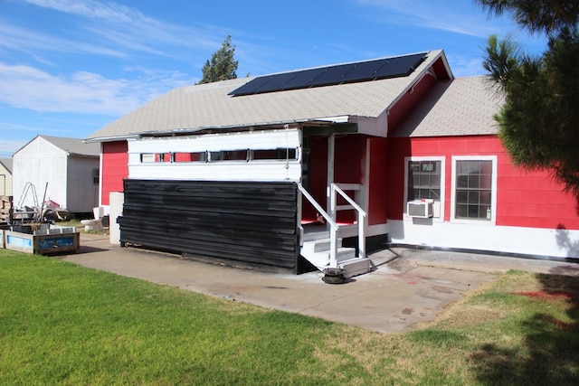 2711 W 83rd St, Odessa, TX 79764 - view of front of home featuring roof mounted solar panels, a front yard, roof with shingles, and cooling unit