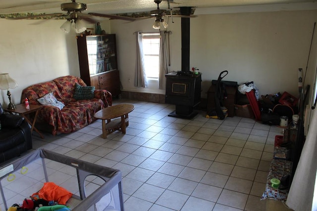 2711 W 83rd St, Odessa, TX 79764 - living room with a wood stove, a ceiling fan, and light tile patterned floors