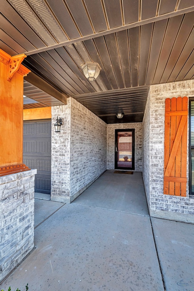 doorway to property with brick siding