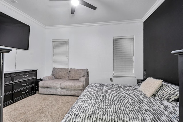 carpeted bedroom with ornamental molding and a ceiling fan