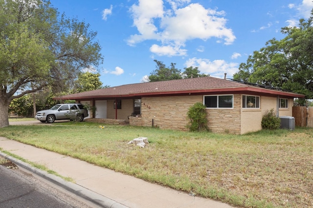 2110 Redbud Ave, Odessa, TX 79761 - view of home's exterior with stone siding, central air condition unit, a garage, and concrete driveway