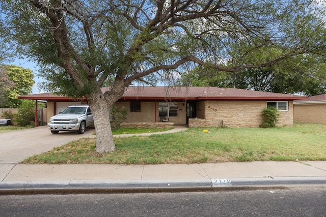 2110 Redbud Ave, Odessa, TX 79761 - single story home featuring a front yard, a garage, driveway, and stone siding