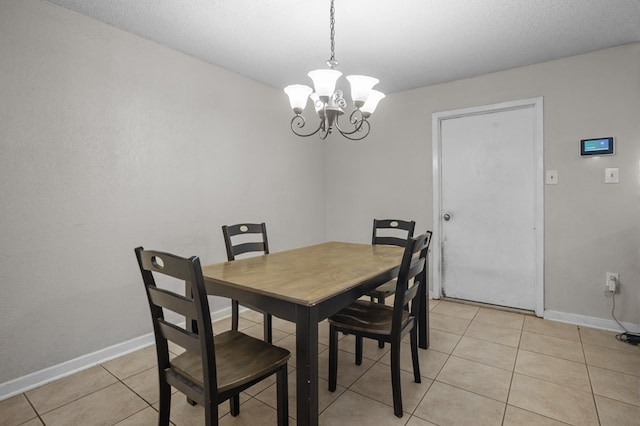 2110 Redbud Ave, Odessa, TX 79761 - dining room with a chandelier, baseboards, and light tile patterned floors