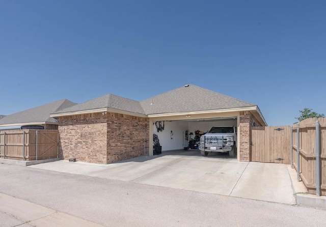 4402 Guadalupe, Midland, TX 79707 - view of home's exterior featuring brick siding, a gate, a garage, and concrete driveway