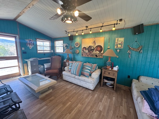 303 Squaw Valley Trl, Fort Davis, TX 79734 - living room with ceiling fan, wood finished floors, lofted ceiling, rail lighting, and wood walls
