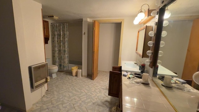 1408 Emerson Ave, Mccamey, TX 79752 - bathroom featuring heating unit, toilet, and vanity
