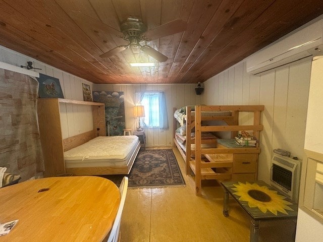 407 N Phelps St, Alpine, TX 79830 - bedroom featuring wood ceiling, a wall unit AC, wood finished floors, wooden walls, and ceiling fan