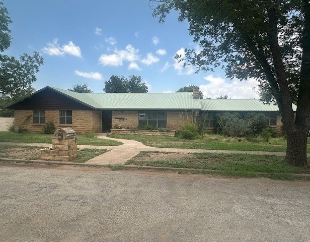 407 N Phelps St, Alpine, TX 79830 - single story home with a chimney and metal roof