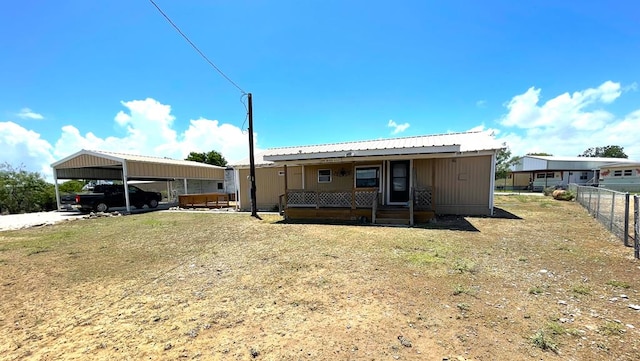 view of front of property with a carport and covered porch