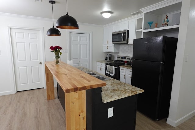 3020 W 15th St, Odessa, TX 79763 - kitchen with appliances with stainless steel finishes, butcher block countertops, light wood finished floors, open shelves, and white cabinetry