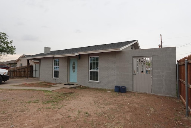3020 W 15th St, Odessa, TX 79763 - view of front of house featuring a chimney and brick siding