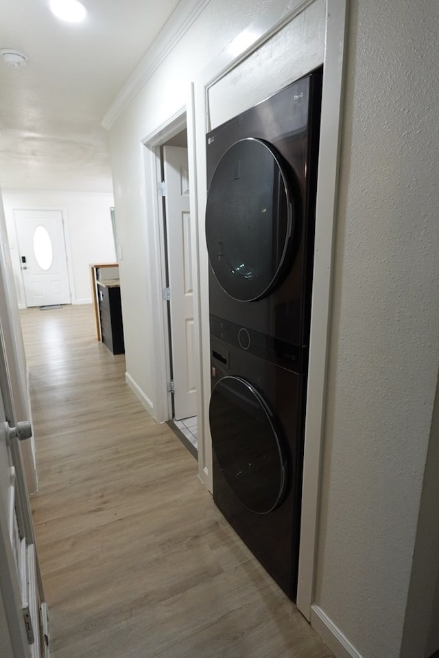 3020 W 15th St, Odessa, TX 79763 - laundry room with stacked washer / drying machine, light wood-style flooring, and ornamental molding