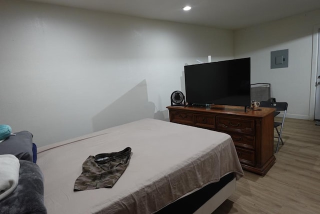 3020 W 15th St, Odessa, TX 79763 - bedroom with light wood-style floors, electric panel, and recessed lighting