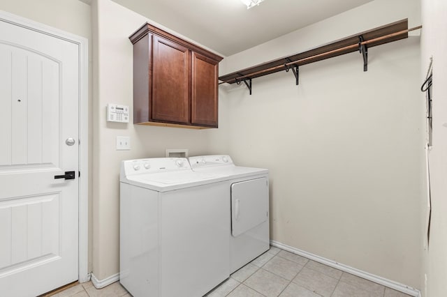 304 E 94th St, Odessa, TX 79765 - laundry area with cabinet space, washer and clothes dryer, and light tile patterned floors