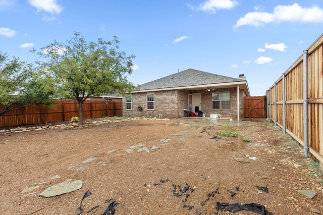 304 E 94th St, Odessa, TX 79765 - rear view of property featuring a fenced backyard, a patio area, brick siding, a shingled roof, and a gate