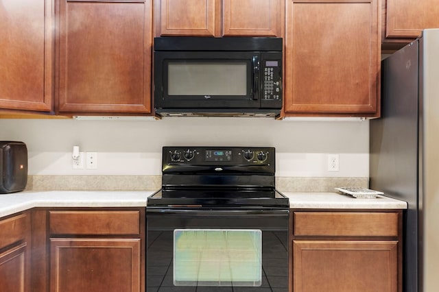 304 E 94th St, Odessa, TX 79765 - kitchen with black appliances, light countertops, and tile patterned floors