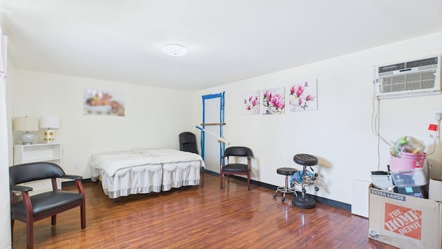912 W 7th St, Pecos, TX 79772 - bedroom with wood finished floors and a wall mounted AC